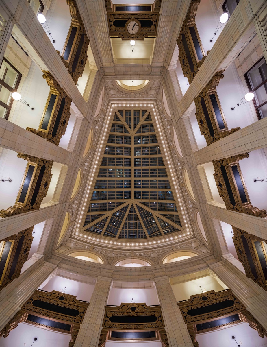 The David Whitney Building is one of the most important structures in Detroit.

First, it is one of only three surviving buildings in Detroit by the renowned architectural firm of Daniel H. Burnham &amp; Co. Burnham is considered one of the most important American architects of all time. Second, the building's atrium lobby is one of the most jaw-dropping in the city, a veritable terra cotta smorgasbord. And lastly, it is one of the increasingly few landmarks ringing Grand Circus Park.
Meet David Whitney

The building is named in honor of David Whitney Jr., one of the men responsible for much of Detroit's early commercial and industrial development. The lumber baron and shipping magnate was born in 1830 in Massachusetts, coming to Michigan in 1857 to take advantage of the state's fledgling lumber industry. In addition to his success in the lumber business in Michigan, Oregon and Washington state, Whitney also invested in Great Lakes shipping. In fact, an article in the Detroit Sunday News Tribune from 1895 quoted others in the industry as saying Whitney "is the best prophet of vessel rates on the Lakes." He also invested in many of Detroit's banking, industrial and insurance companies, "and his extensive lending of money made him an extremely important figure in the commercial and industrial development of Detroit before the turn of the century," wrote William M. Worden in his proposal for making the David Whitney Building its own historic district.

By the turn of the century, he was one of Detroit's wealthiest men and largest landowners. His fortune was estimated at $7 million to $10 million in the 1890s, the equivalent of $167.7 million to $239.5 million today, when adjusted for inflation. His land in Wayne County, which includes Detroit, was estimated to be worth $2 million ($47.9 million today). And not only did he own a lot of the city's land, he owned many of the best pieces of land. An 1895 newspaper article on Detroit property barons indicated that Whitney's property "equaled that of any other five men in Detroit." His home, now a restaurant known as The Whitney, is a 21,000-square-foot mansion on the west side of Woodward Avenue, in what is now known as Midtown.
How a monument was born

The land on which the David Whitney Building sits was acquired by Whitney, though he did not have the structure built.

During Whitney's lifetime, Grand Circus Park was a residential area with no real retail to speak of. In fact, aviator Charles Lindbergh's mother, Evangeline Land Lindbergh, was born in 1876 on the site where the Whitney Building stands now. The Church of Our Father was in the neighborhood, home to Detroit luminaries such as John Judson Bagley, a wealthy tobacconist and governor of Michigan. Whitney bought the parcel on the southwest corner of Woodward and Park avenues in 1885 from H.H. LeRoy. Whitney, having an eye for shrewd business moves, saw the Woodward's business district would be expanding northward as the city grew. In 1887, he built the five-story Grand Circus Building, which was home to five stores. And the little commercial store was sitting there among the homes on the park when its millionaire owner died in 1900.

It was Whitney's son, David Charles Whitney, who would built a monument to his father. David C. Whitney was a banker and real estate developer. He demolished the Grand Circus Building in early 1914 and hired one of the best in the business: Daniel H. Burnham. The Whitney Realty Co. received building permit No. 317 on Feb. 5, 1914, and began erecting the 18-story David Whitney Building. The cost: $1 million, or about $22.7 million today. Many of the contractors on the job were Detroit companies.

The Whitney Building, billed as "an exclusive shopping center," opened in January 1915. What made the building stand out was its dramatic, skylight-covered, four-story atrium lobby. The entire room is covered with either decorative terra cotta or marble. All four floors are ringed with storefronts. Among them: Capper &amp; Capper men's furnishings, G.M. Schettler Drugs, Rogers Shoe Co. and the Watkins Cigar Stores Co. For the Detroiter of 1915, the Whitney Building was a one-stop shop for clothing, tailors, hairdressers and milliners. "The shops of the David Whitney Building have attained reputations as enviable as New York's smart shops," a promotional brochure called "When Royalty Shops," said. "Prices are really moderate."

From the fifth through 18th floors, the Whitney Building contained office space available for rent. Many of these floors housed many dentists, doctors and lawyers.
The "Mad Men" era

The Whitney Building's decline mirrors almost every other office structure in Detroit. During the 1950s, thanks to the advent of the freeway system and the rise of the suburbs, the city's population started moving out - and the doctors, dentists and lawyers went with them. The suburbs offered less congestion, cleaner and quainter streets and neighborhoods, cheaper rents and more modern structures.

The age of fluorescent lighting and faux wood paneling, Americans were turning away from classical architectural styles and opting for the modern aesthetic. Starting in the mid-1950s and through the mid-1960s, the city saw the demolition of its Old City Hall and first skyscraper; the Detroit Symphony Orchestra leave its near-acoustically perfect Orchestra Hall for the modern Ford Auditorium; and countless buildings shave off their cornices and install drop ceilings in what were once soaring lobbies. What some could now call the "Mad Men" era was not kind to Detroit's historical architecture.

The David Whitney Building was among the casualties. While it was spared the wrecking ball, in 1959, the Whitney family hired the architectural firm of Harley, Ellington &amp; Day to give the structure a modern makeover. The building's classical exterior was removed in favor of a more modern, bland look. The building's classical columns were replaced with plain brick. The cornice, parapet and terra cotta details were removed. Fortunately, the building's ornate interior was spared the mutilation. The surgeon was Bryant &amp; Detwiler &amp; Co.
Tough times

The Whitney family sold the building in 1965. At the time, it was still 95 percent occupied and was home to nearly 300 dentists and doctors. But two years later, the Detroit race riot of 1967 when speed up what had started a decade earlier: the draining of the city' population.

One office after another was left empty until the 1980s, when the building was really put on the ropes. The building was all but empty in May 1999, when it was announced that new owners planned to turn the landmark into a hotel. This plan never happened, and the building was closed in 2000.
Hope for a rebirth

In January 2011, the city's Downtown Development Authority approved a mixed-use redevelopment plan and the loan of $1 million to help Whitney Partners buy the tower. The building was sold for $3.3 million.

Whitney Partners includes the Roxbury Group, a Detroit real estate investment group, and Trans Inn Management, a Farmington Hills-based real estate company with investments in more than a dozen states.

In March 2013, Gov. Rick Snyder cut the ribbon on an $82-million reconstruction project for the building.

Following a $92 million renovation that not only restored the Whitney's original classically inspired exterior, but spiffed up its stunning four-story lobby, the Aloft "boutique" hotel opened in December 2014. A symbolic flicking of the switch illuminated the Whitney's facade for the first time in years on Dec. 15. Descendants of David Whitney were on hand for the ceremony.

The hotel features 136 rooms. The rest of the skyscraper was turned into 105 apartments
